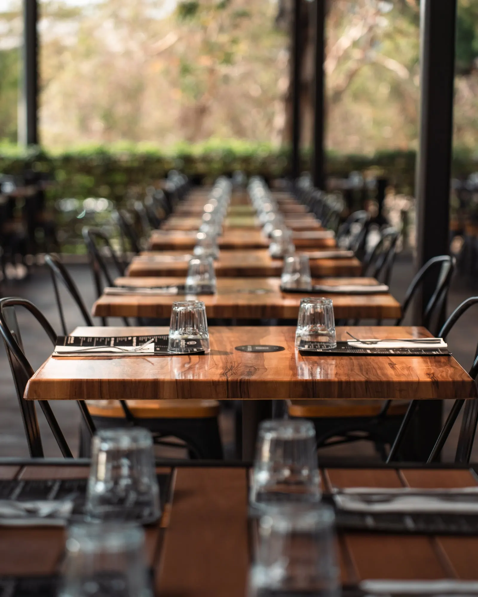 Long tables set for service at an Andonis cafe